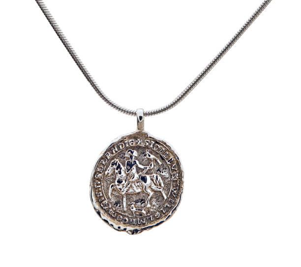 Golden necklace with silver coin isolated on white