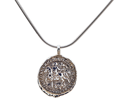 Golden necklace with silver coin isolated on white.