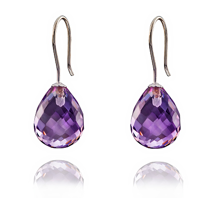 Golden earrings with Amethyst gemstone isolated on white background.