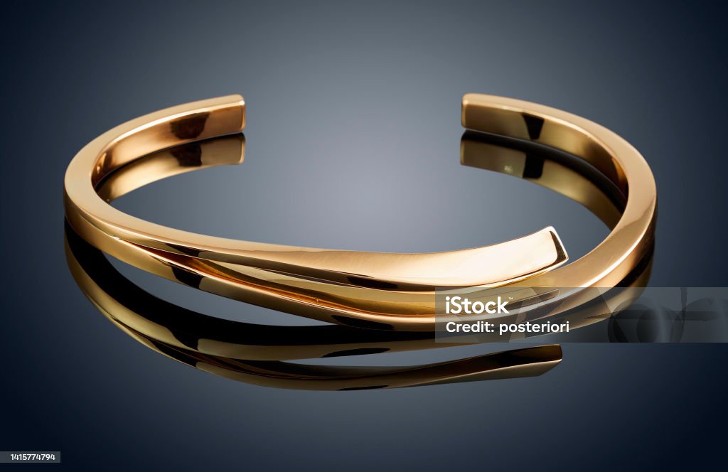 golden bracelet isolated on grey background golden bracelet isolated on grey background. Bracelet Stock Photo