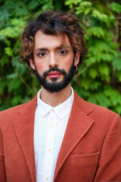 istock Stylish businessman with makeup looking at camera while standing outdoors. 1415775788