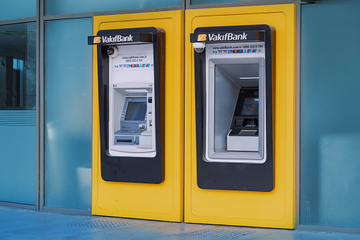 10 July 2022, Antalya, Turkey: Two ATMs for money withdrawal at the Vakif bank financial department office. Deposit and money savings account concept