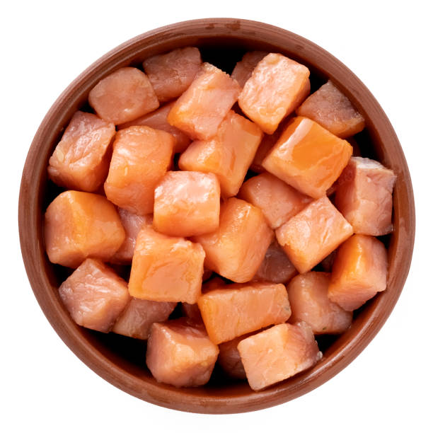 Salmon cut into cubes in a bowl stock photo