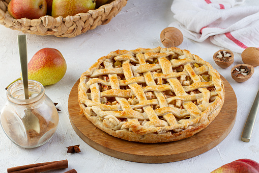 Homemade autumn or Summer apple pie with fresh apples, spices, cinnamon and ice cream on rustic wooden background, top view. Thanksgiving Day concept, harvest time.