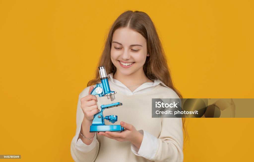 positive child with microscope on yellow background positive child with microscope on yellow background. Child Stock Photo