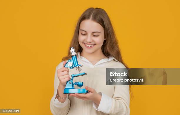 Positive Child With Microscope On Yellow Background Stock Photo - Download Image Now