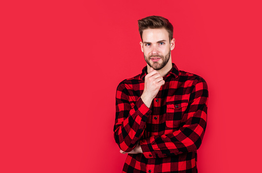 handsome man wear checkered shirt. unshaven guy in casual style. male hairdresser and barbershop. male beauty trend. bearded man with sexy bristle. facial hair and skin care. copy space.