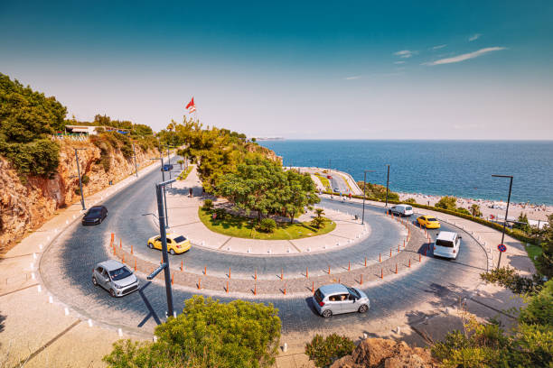Cars and motorcycles climb the winding serpentine road to the observation deck with the Turkish flag and a wonderful view of the sea stock photo