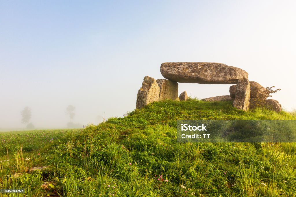 Stone age passage grave on a hill with mist Ancient Stock Photo