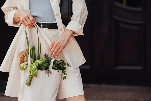 Unrecognisable Stylish Woman Holding Shopping the Eco Bag with Groceries Outdoors, Copy Space