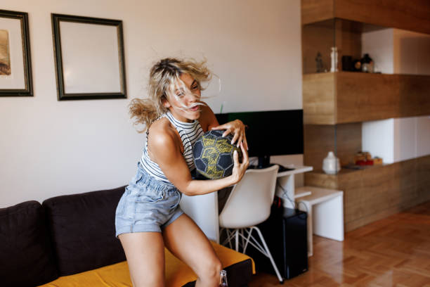istock Female fan watching match at home 1415785488