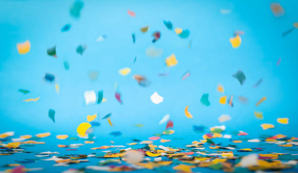 Colorful confetti in front of blue background