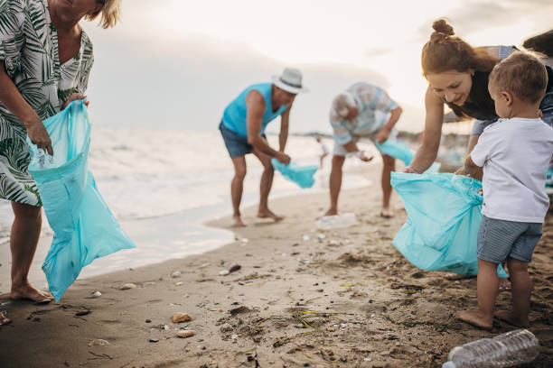 istock Group of people cleaning beach 1415788248