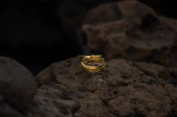 istock Rings - Gold rings in a stone rock 1415788850