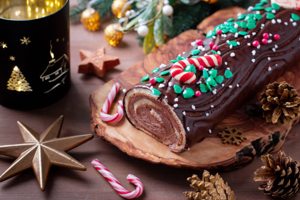 istock Traditional chocolate trunk cake or log cake on table with Christmas decorations 1415790026