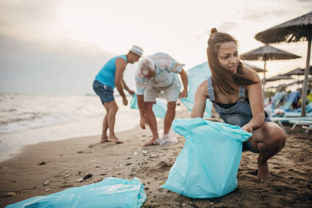istock Group of people cleaning beach 1415791659