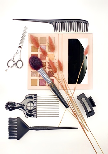 A set of decorative cosmetics on a light colorful background. A set of tools for a hairdresser. Beauty salon and facial care. Fashion industry.