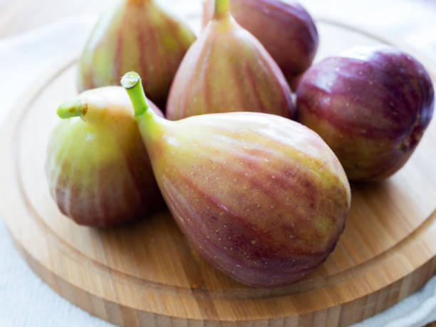 istock Fresh Figs On A Wooden Board 1415793538