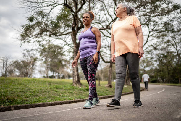 istock Senior women walking in a park 1415794333