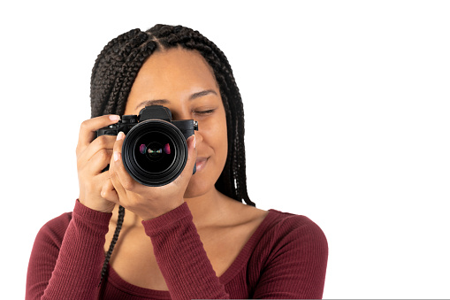 Close up portrait of a young black woman with a photo camera in the studio