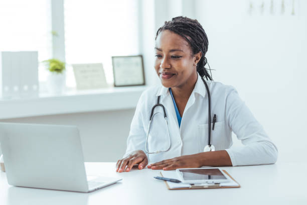 istock Female doctor therapist has a video call conference with a patient using a web camera in a hospital. 1415794637