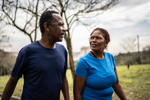 istock Senior couple walking in a park 1415795366