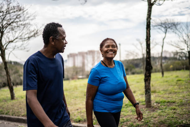 istock Senior couple walking in a park 1415795369