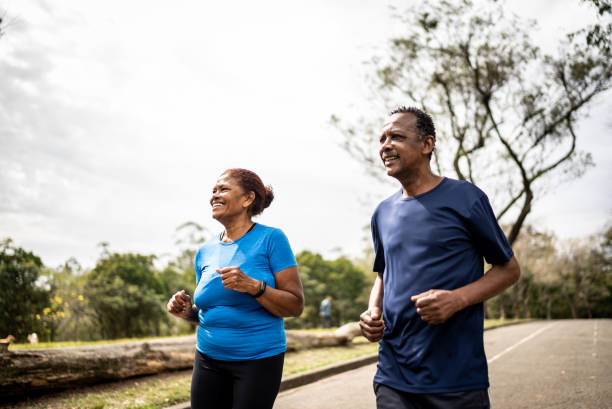 istock Senior couple walking in a park 1415795376