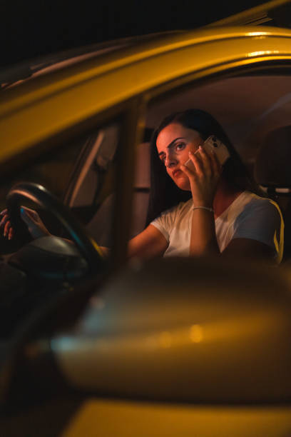 istock Frustrated young woman using her phone while sitting in the car 1415796537