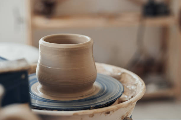 istock Close Up of Clay Pot on a Pottery Wheel in Ceramic Studio 1415796652