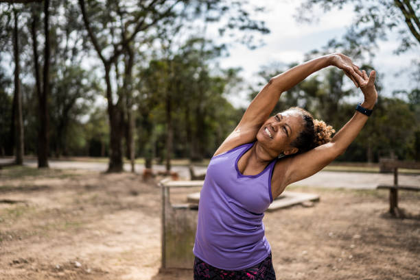 istock Senior woman stretching in a park 1415796840