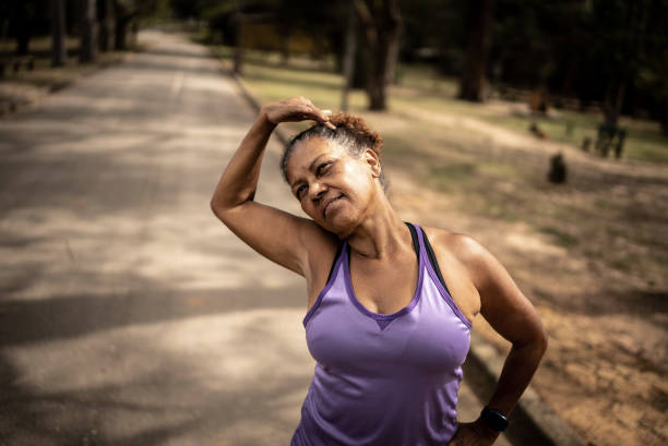 istock Senior woman stretching in a park 1415796841