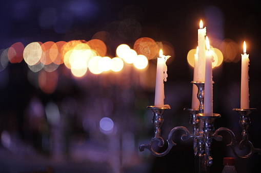 Metal retro candlestick with burning candles