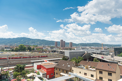 Zürich, Switzerland - July 30 2022: High angle view of the city of Zürich from the top of the Freitag store in Zürich-West. The main station and the railway are visible.