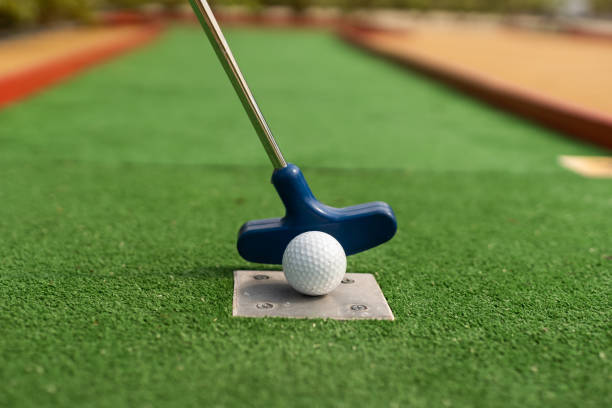 istock A club prepares to hit a ball during a mini golf game 1415800123