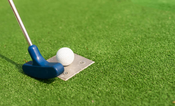 istock A golf club and a ball during a mini golf game 1415800765
