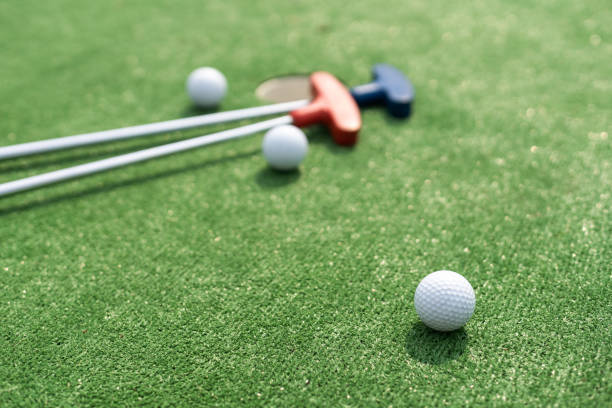 Close-up of miniature golf hole with bat and ball stock photo