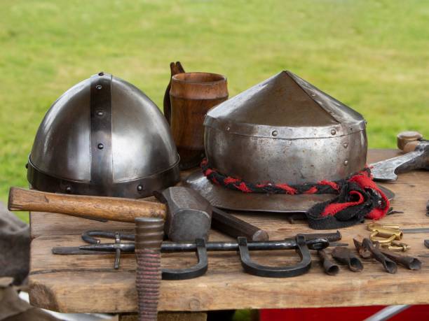 istock Collection Of Medieval War Helmets & Forge Implements. 1415801302