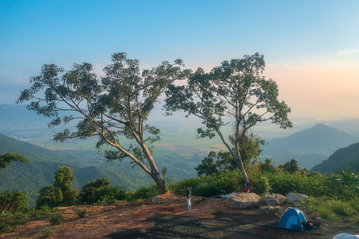 Photographer camping for landscape photography on Dac Loc mountain peak, Nha Trang city, Khanh Hoa province