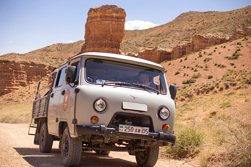 July 6, 2022, kazakhstan, charyn canyon. off-road taxi 4x4 bringing people from the river valley to the plateau