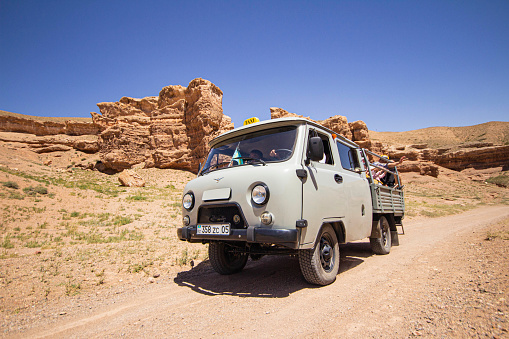 July 6, 2022, kazakhstan, charyn canyon. off-road taxi 4x4 bringing people from the river valley to the plateau