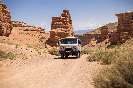 July 6, 2022, kazakhstan, charyn canyon. off-road taxi 4x4 bringing people from the river valley to the plateau