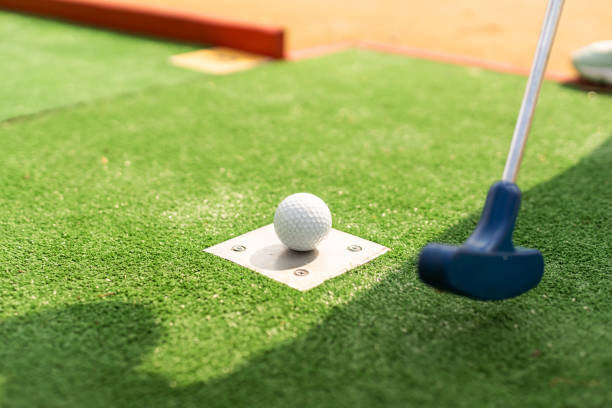 istock A club prepares to hit a ball during a mini golf game 1415802448