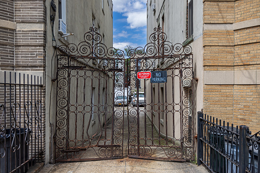 Long Island City, Queens, New York, NY, USA - July 7th 2022: Driveway closed by a gate between two buildings