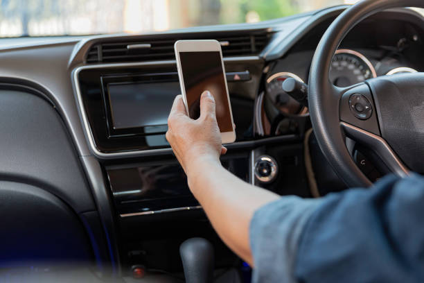 istock Hand press hand phone in car while driving. dangerous 1415803181