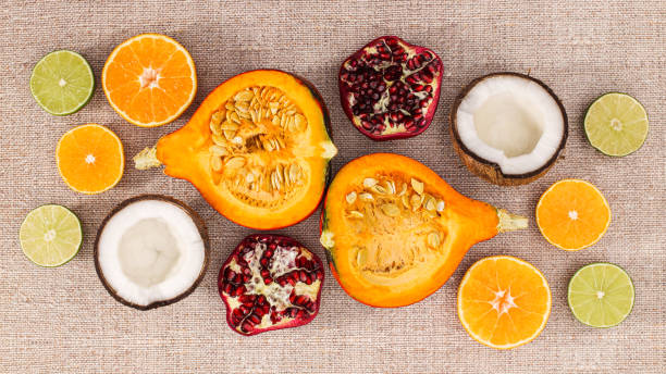 istock Sliced fresh exotic fruits on beige background. Flat lay summer concept 1415804556