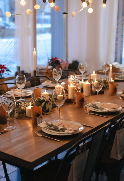 istock Christmas evening. Stylish table design. Serving with candles, eucalyptus, garlands and white plates. High quality photo 1415804626