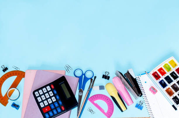 istock top view of school subjects on a blue background with space for text, school concept 1415804875