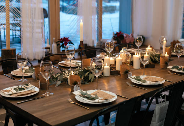 istock Christmas evening. Stylish table design. Serving with candles, eucalyptus, garlands and white plates. High quality photo 1415804968