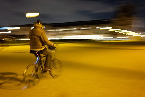 People riding home at night along the Tuileries park